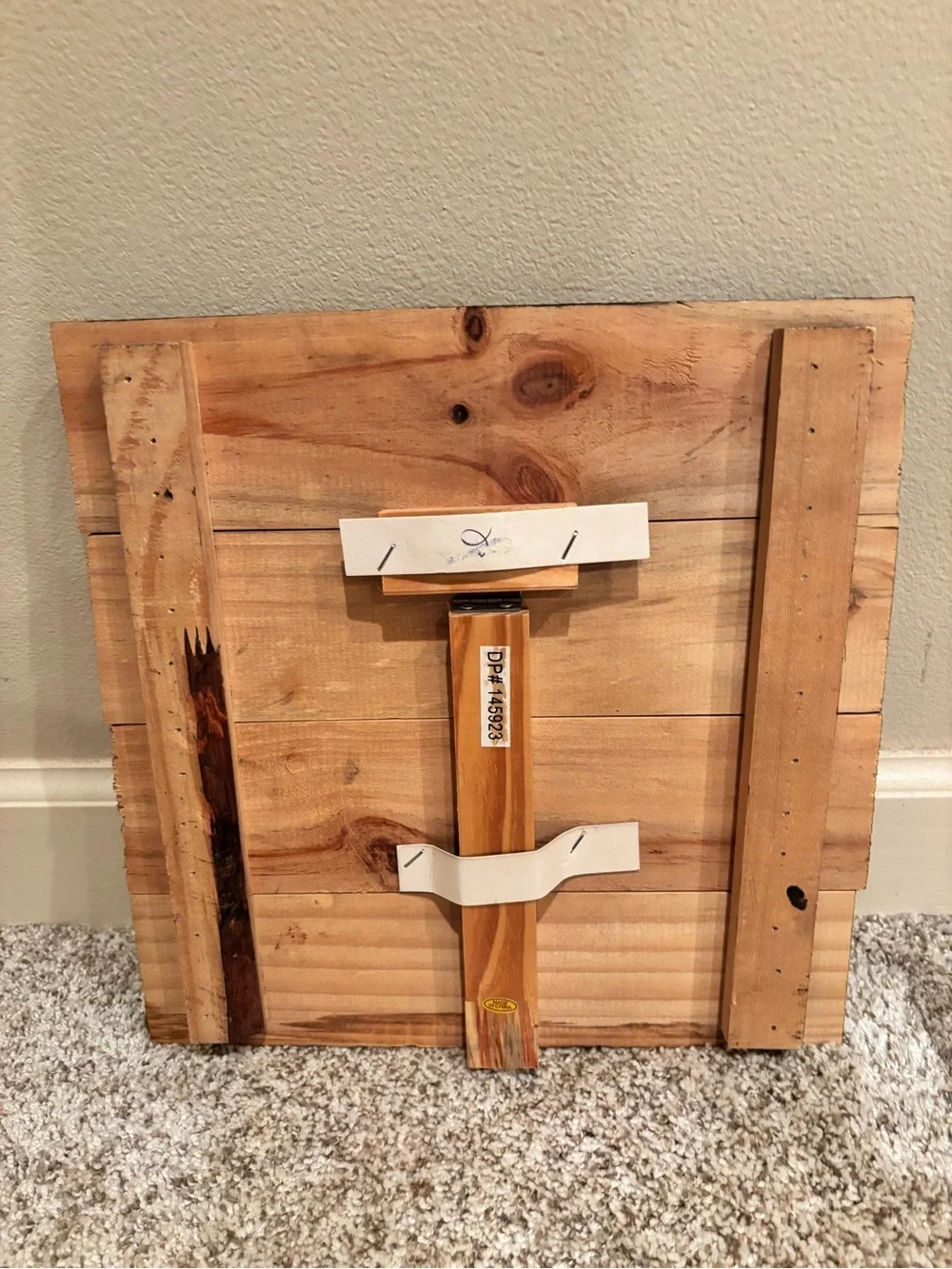 Wooden square decor with three gold clips to hold photos.
